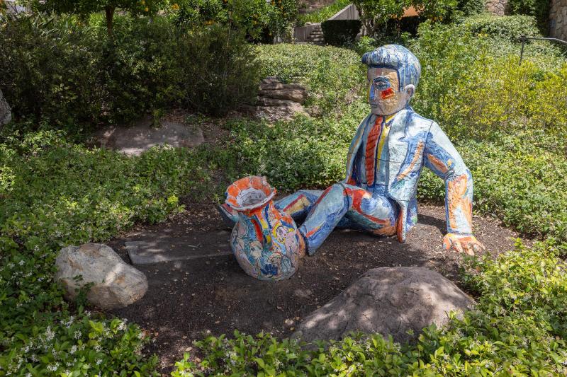 Outdoor sculpture of man with pottery