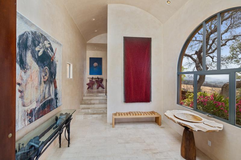 Interior foyer with artwork and arched window