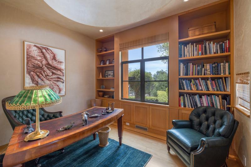 Office with leather chair and bookshelves
